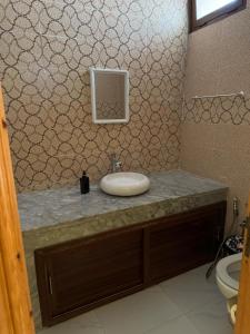 a bathroom with a sink and a toilet at Al Kasbah Resort in El Jadida