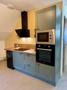 a kitchen with a stove and a microwave at Appartement à Ohain in Ohain +19 photos