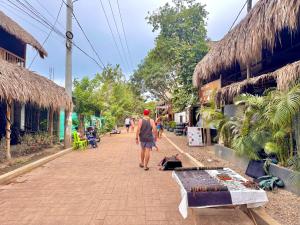 a man walking down a street in a village at Cilipo House in Palomino