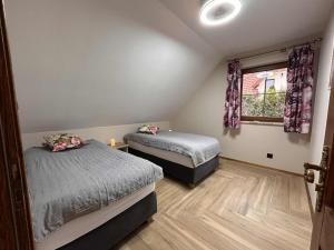 two beds in a room with a window at BABA JAGA na szlaku in Nowa Słupia