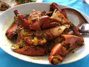 a bowl of food on a table with a spoon at Hotel Takia in Labasa