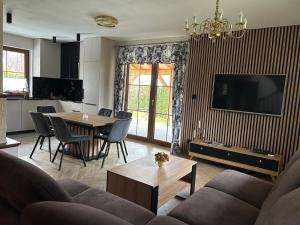 a living room with a couch and a table at BABA JAGA na szlaku in Nowa Słupia