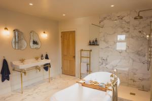 a bathroom with a tub and a sink and a shower at Luxury House sleeps 14 with Secret Bar near Bath in Warminster +45 photos