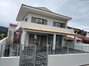a house with a gate in front of it at Anna Coast Apartment in Agia Anna