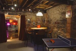 a bar with a table and chairs in a brick wall at Luxury House sleeps 14 with Secret Bar near Bath in Warminster