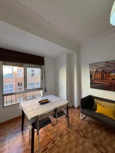 a living room with a table and a couch at The Ruzafa by Laura - AVE in Valencia