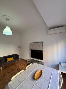 a living room with a table and a couch at The Ruzafa by Laura - AVE in Valencia