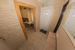 a small hallway with a door and a table at Matrakapuvendeghaz in Mátraszőlős +22 photos