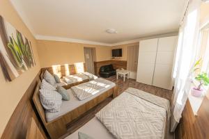 a living room with a bed and a couch at Matrakapuvendeghaz in Mátraszőlős
