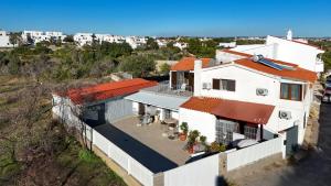 an aerial view of a white house with an orange roof at Modern Duplex Close to the Beach in Armação de Pêra