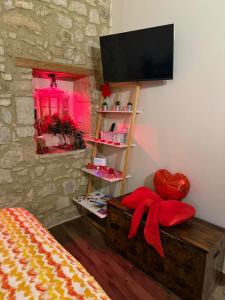 a bedroom with a tv on the wall and a bed at Il Richiamo della Cascata in Papigno