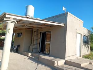 a small house with a porch and a window at Casa de luna in San Lorenzo