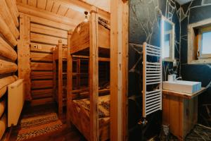 a bedroom with bunk beds in a log cabin at Granddrevenica in Malá Franková +32 photos