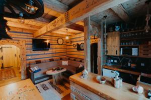 a living room with a couch and a table in a cabin at Granddrevenica in Malá Franková