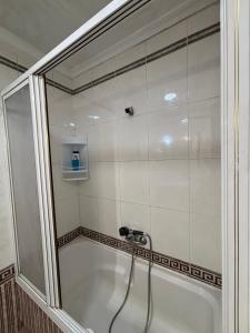 a bathroom with a shower with a sink at The Ruzafa by Laura - AVE in Valencia +17 photos