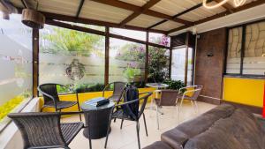 a living room with a table and chairs and a couch at Hotel estación Kristal - Corferias in Bogotá