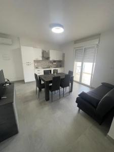 a living room with a table and chairs and a couch at Brezza Marina - Vacation Condo in Marina di Vasto +14 photos