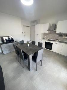 a kitchen with a dining room table and chairs at Brezza Marina - Vacation Condo in Marina di Vasto