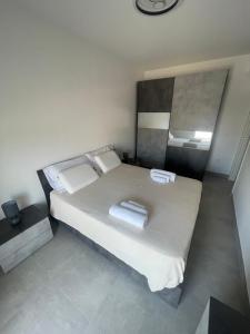 a bedroom with a large bed with two towels on it at Brezza Marina - Vacation Condo in Marina di Vasto