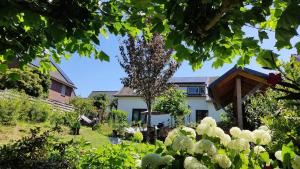 a house with a garden in front of it at Bed and Breakfast Bergs Huuske in Sint Odiliënberg