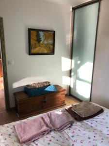 a bedroom with a bed with a dresser and a mirror at Budha house in Lošonec