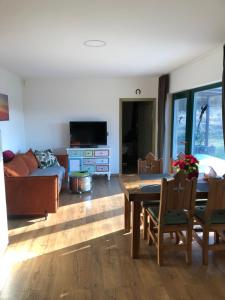 a living room with a table and a couch at Budha house in Lošonec