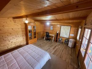 a bedroom with a large bed in a wooden room at La Marciana - piscina pista tenis futbol y baloncesto privado - Bungalow externo independiente in Chiclana de la Frontera +30 photos