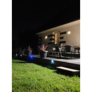 a patio at night with potted plants on it at dom na gwarnej in Osłonin