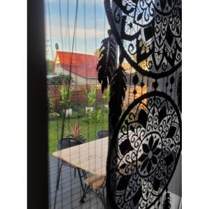 a window with a table and a view of a yard at dom na gwarnej in Osłonin +5 photos