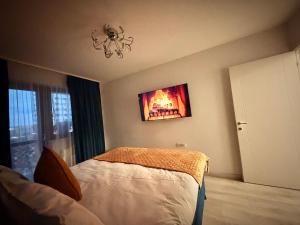 a bedroom with a bed and a painting on the wall at Hils Pallady in Bucharest