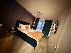 a small bedroom with a bed and a window at Hils Pallady in Bucharest