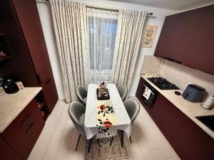 a kitchen with a table and chairs in a kitchen at Hils Pallady in Bucharest +3 photos