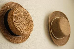 two straw hats are next to each other at Casa Côrte Real in Porto