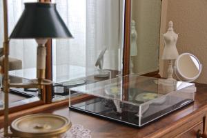 a glass table with a lamp and a mirror at Casa Côrte Real in Porto +35 photos