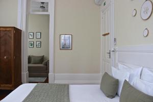 a bedroom with a bed and a chair in it at Casa Côrte Real in Porto