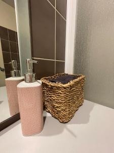 a bathroom with two wicker baskets and a mirror at Calais plage, superbe studio tout confort in Calais +13 photos