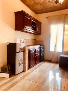 a kitchen with a white refrigerator and a window at appartment émeraude in Kribi