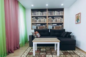 a living room with a couch and a table at Apart Lawina in Sumy