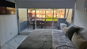 a bedroom with a bed and a view of a balcony at Apartamentos del campus in Presidente Derqui