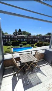 a patio with two chairs and a swimming pool at Apartamentos del campus in Presidente Derqui