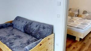 a living room with a couch and a bed at Alpenrose Ferienwohnung in Balderschwang