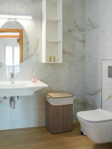 a bathroom with a sink and a toilet at Ostria View in Kardamaina +53 photos