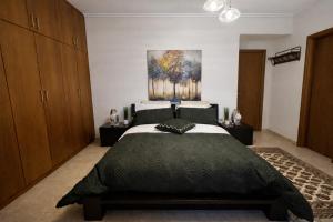 a bedroom with a bed and a painting on the wall at Casa Verde Pastida in Pastida +13 photos