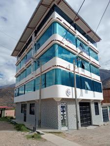 a building with glass windows on a street at Mishki Punuy in Caraz