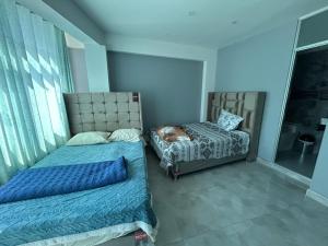 a bedroom with two beds and a dog sleeping on a bed at Mishki Punuy in Caraz +2 photos
