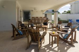 a group of tables and chairs in a patio at Sandgate in Bridgetown