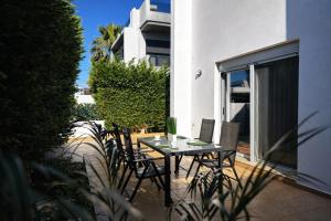 a table with chairs and a laptop on a balcony at Casa Verde Pastida in Pastida