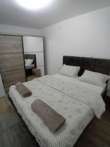 a bedroom with a large bed with a mirror at Stan na dan Bor in Bor