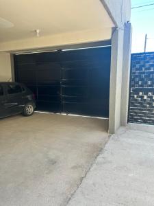 a garage with a car parked in front of it at Cima Departamentos in Rivadavia