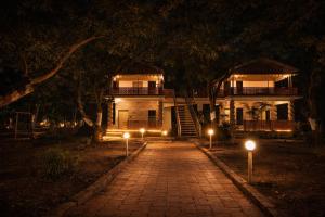 a house at night with lights in front of it at The Wilds Villa Gir Jungle Stay with Swimming Pool in Sasan Gir